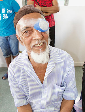 Man smiling with eye cover