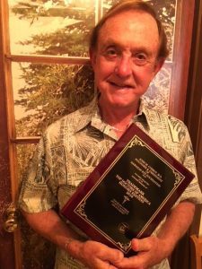 Dr. Corboy man Holding Top Doctor Award